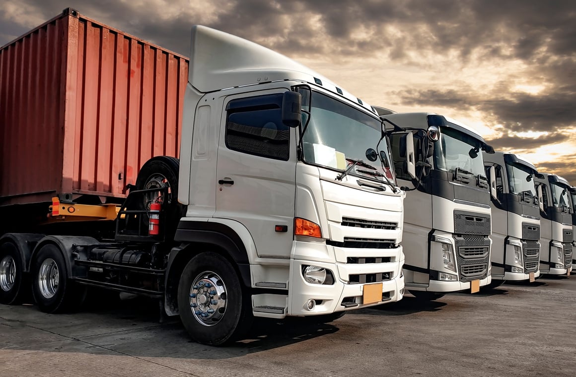 Semi truck trailer on parking at sunset sky. Road freight cargo truck transportation.